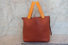 Load image into Gallery viewer, HERMES PICOTIN LOCK TOUCH MM Clemence leather/Swift leather Cuivre/Jaune d'or X Engraving Hand bag 700090134